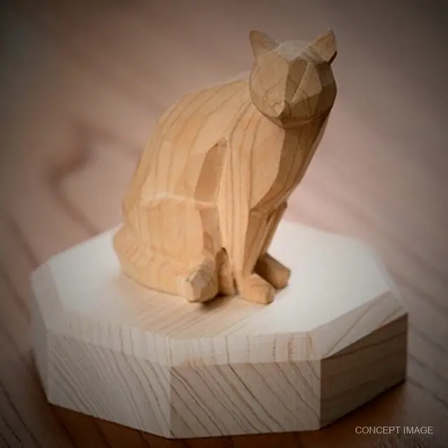 A faceted wooden cat on an octagonal base