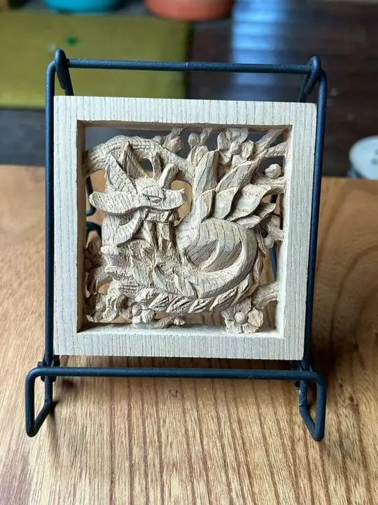 A small framed relief with carved figures