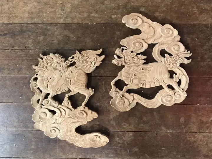 Two shishi relief carvings riding clouds